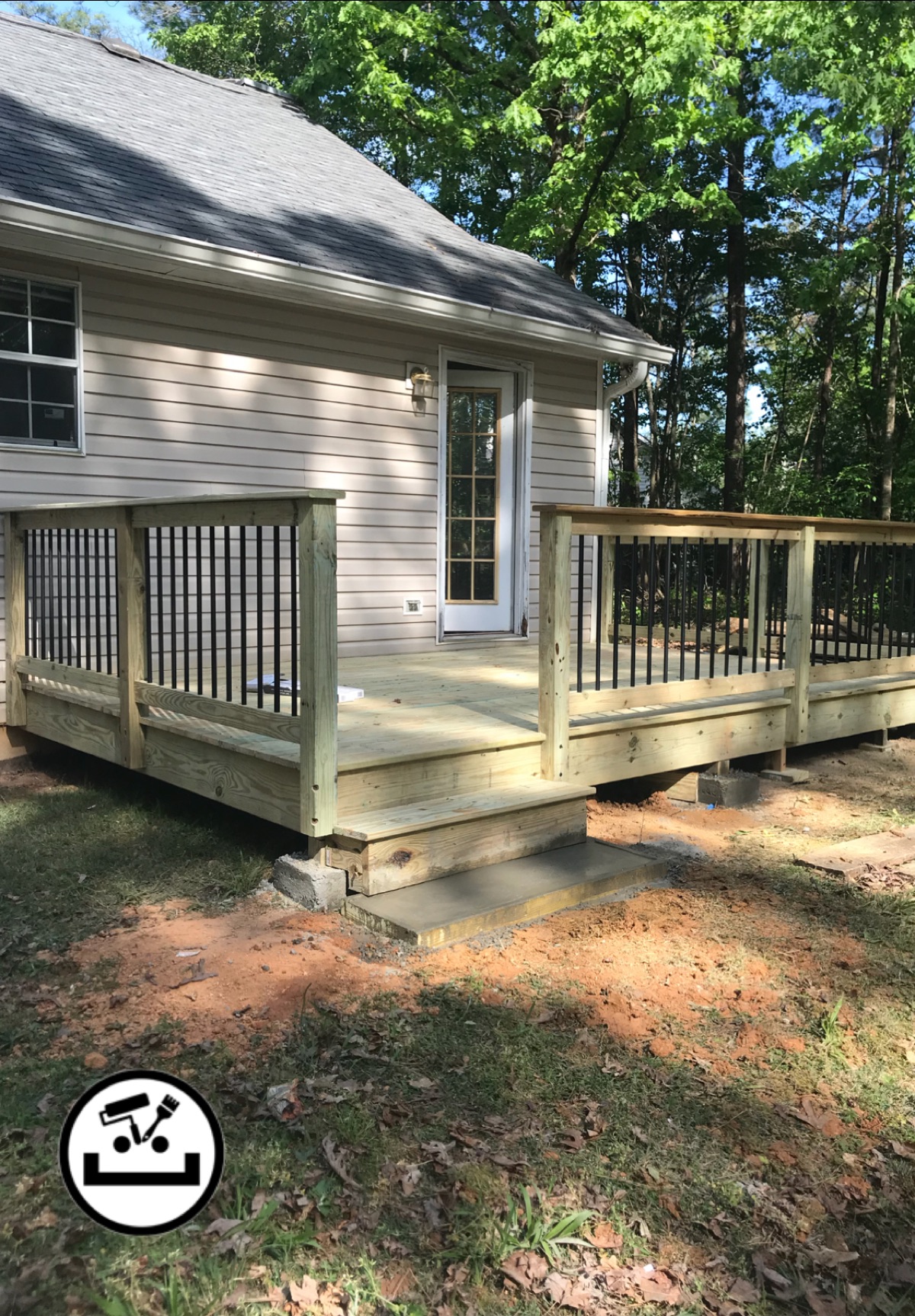 Newly stained pressure-treated deck and railing on a single-story home