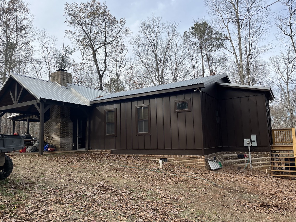 Dark brown board-and-batten ranch exterior, freshly repainted