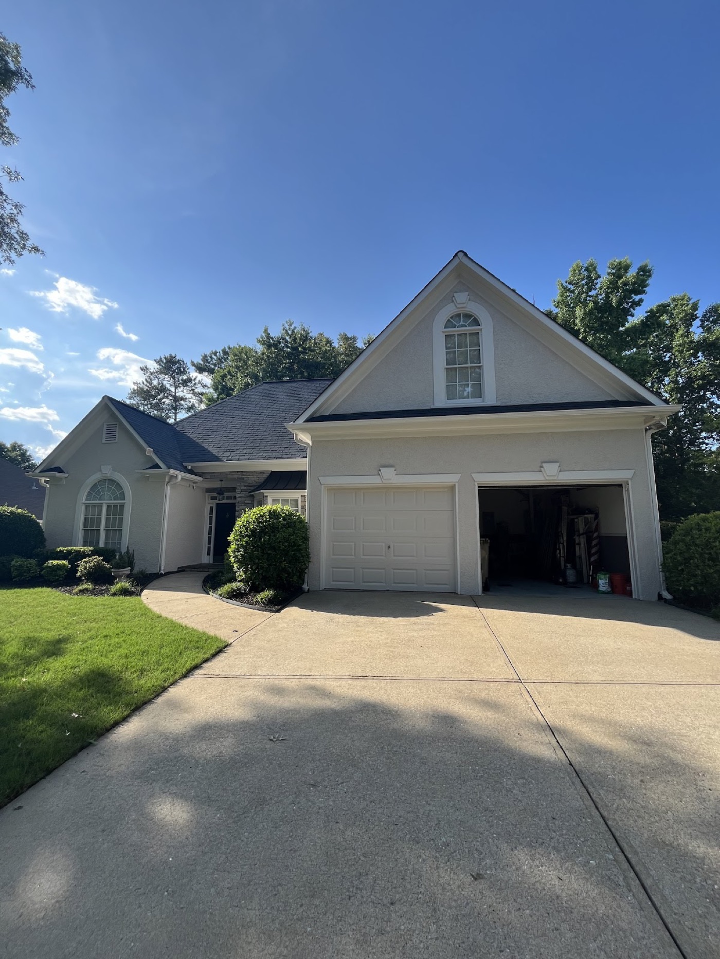 Cream stucco home with a clean two-car garage, freshly painted