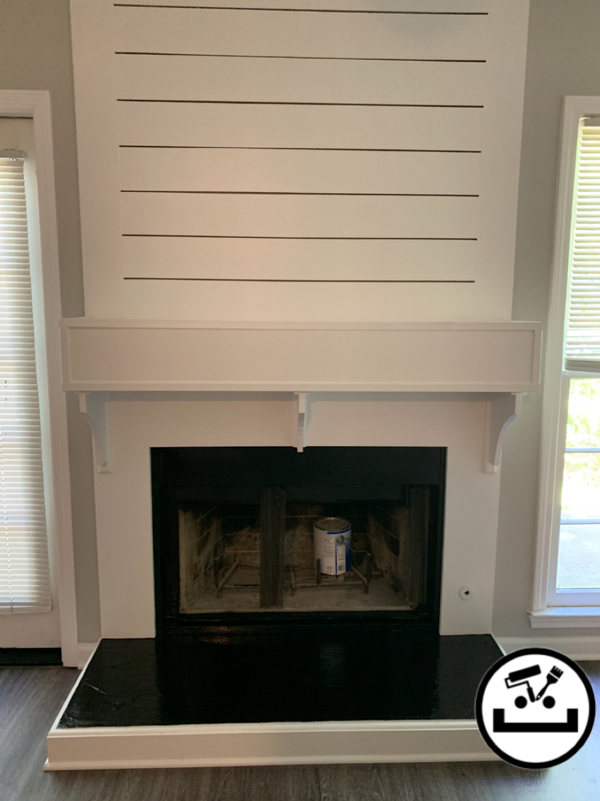 Freshly painted white shiplap fireplace surround with a clean mantel